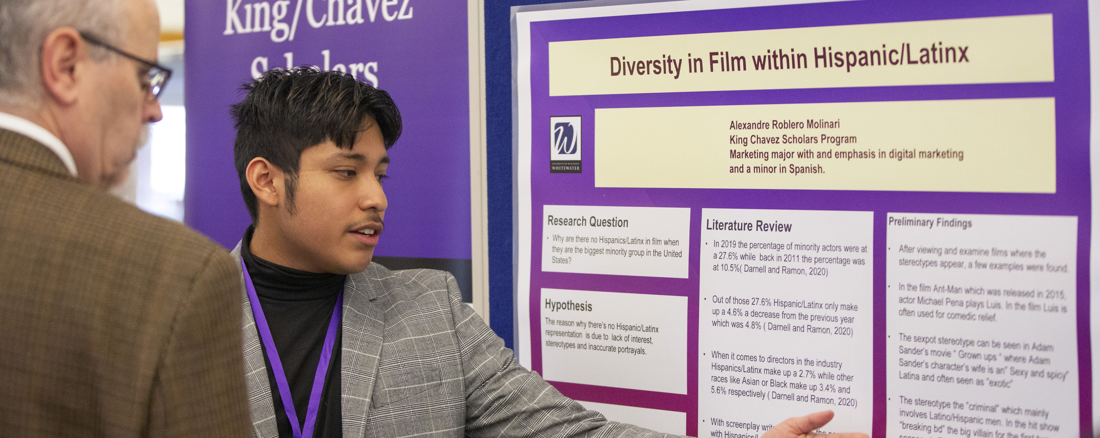 A student explains their posted at undergraduate research.